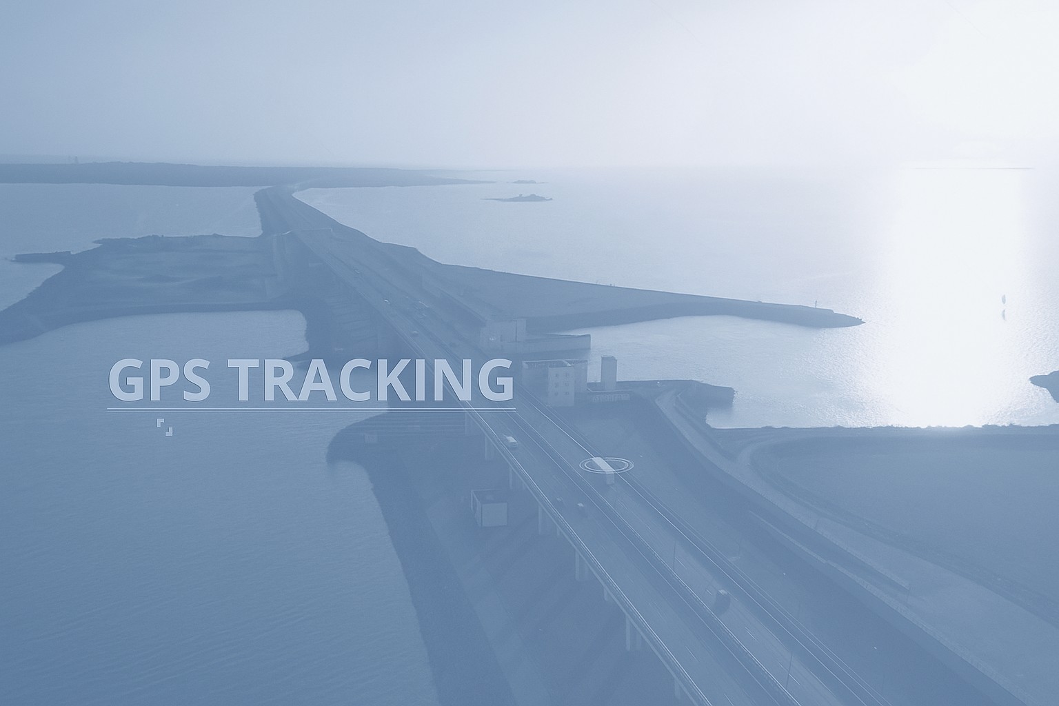 Aerial view of a long highway bridge over water at sunset with GPS TRACKING text overlay